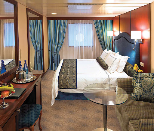 The D Level Ocean View staterooms on Oceania Insignia contain a queen bed with 1,000-thread-count linens, sofa, vanity desk, breakfast table, refrigerated mini-bar, Bulgari amenities, flat-screen TV with live satellite and twice-daily maid service. At 165 square feet, they're on deck 3. 