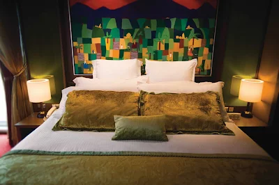 Get a relaxing night's sleep on a king-size bed in Norwegian Pearl's Deluxe Owner's Suite.