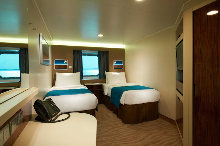 Oceanview rooms in Norwegian's Breakaway cruise feature picture windows and two beds that are convertible into one queen size bed.