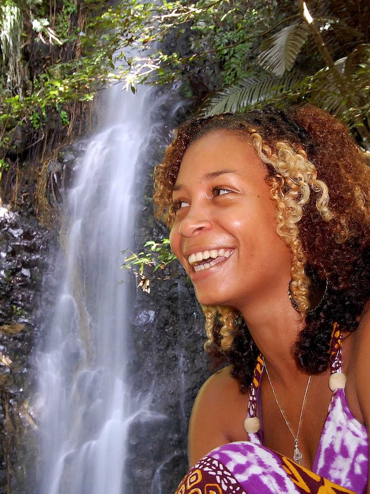 A local girl poses by Dark View Falls on St. Vincent and the Grenadines.
