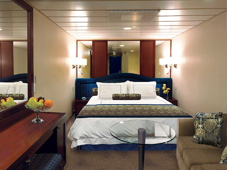 Inside staterooms on Oceania Regatta contain a queen bed with 1,000-thread-count linens, seating area, vanity desk, refrigerated mini-bar, breakfast table, Bulgari amenities, flat-screen TV with live satellite and twice-daily maid service.
