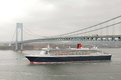 Queen Mary 2 sails beneath the Verrazano Bridge on the Hudson River in New York before making a transatlantic crossing.