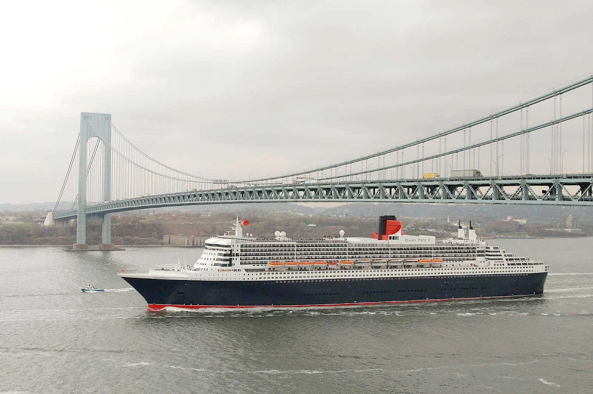 Cunard-Queen-Mary-2-in-New-York - Queen Mary 2 sails beneath the Verrazano Bridge on the Hudson River in New York before making a transatlantic crossing.