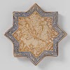 Star-shaped tile with hares among floral scrolls