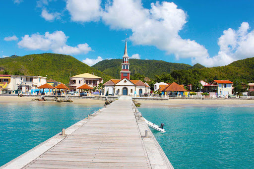 A beautiful view from the docks of Les Anses d'Arlet showcasing the clear waters and French heritage of Martinique.