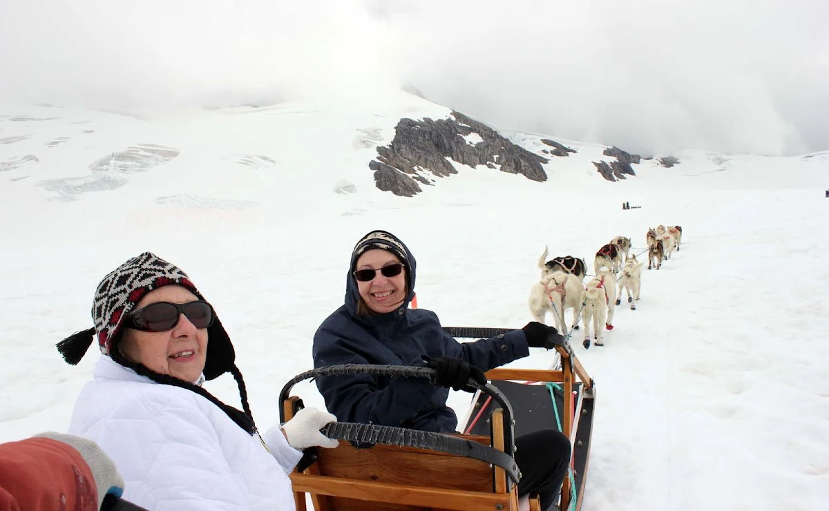 dogsled-Juneau-Alaska - Colleen Hilker: "That's me and my mom on our first sled dog excursion. We started out with a helicopter ride to see the sights around Juneau."