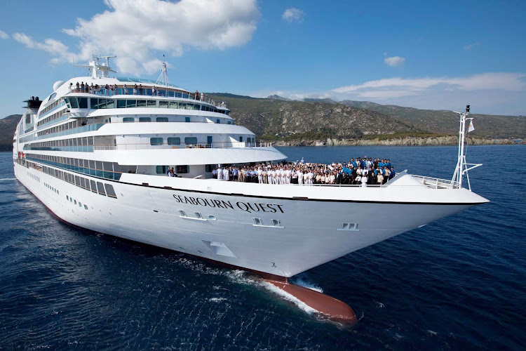 The Seabourn Quest crew poses on the bow of the ship. 