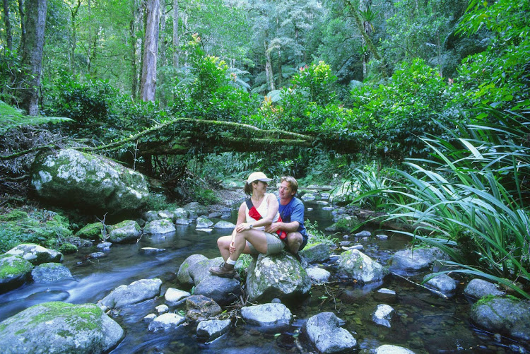 Couple on the Brindle Creek Walk at Border Ranges National Park, Northern Rivers, New South Wales, Australia.