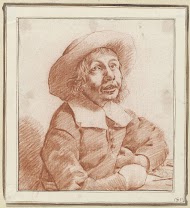 Jongen met hoed, zijn handen rustend op een tafelblad