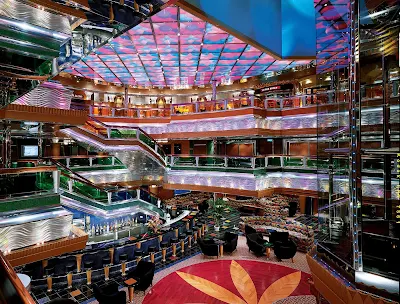 Stroll through a multi-deck kaleidoscope in Carnival Glory's Colors Lobby.