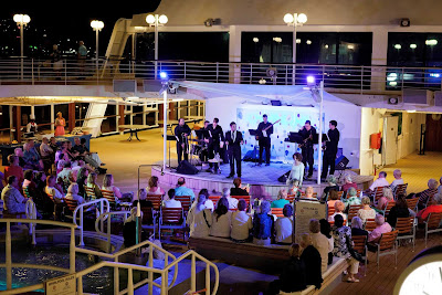 Guests enjoy the tribute to Canadian big band vocalist Michael Buble during an Azamara sailing.