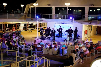 Guests enjoy the tribute to Canadian big band vocalist Michael Buble during an Azamara sailing.