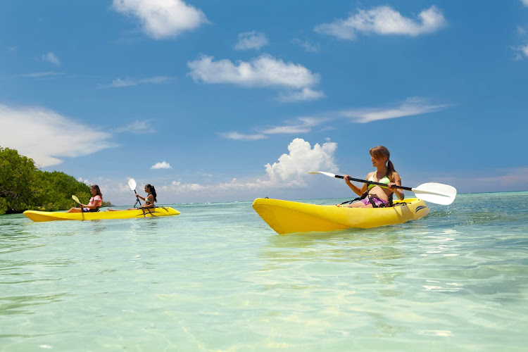 Friends come together to take a kayak tour in the tropical waters of Aruba.