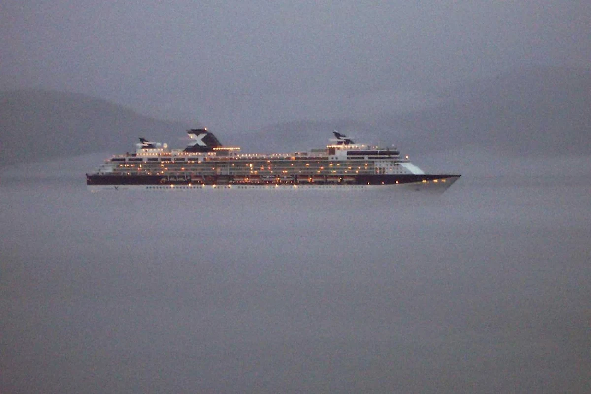 Celebrity-Infinity-mist - Celebrity Infinity sails through the evening mist of Alaska's Inside Passage, northwest of Ketchikan, as seen from her sister ship, Celebrity Millennium.