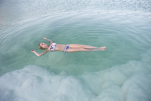 A young woman floats in the Dead Sea, estimated to be the second saltiest major body of water in the world.