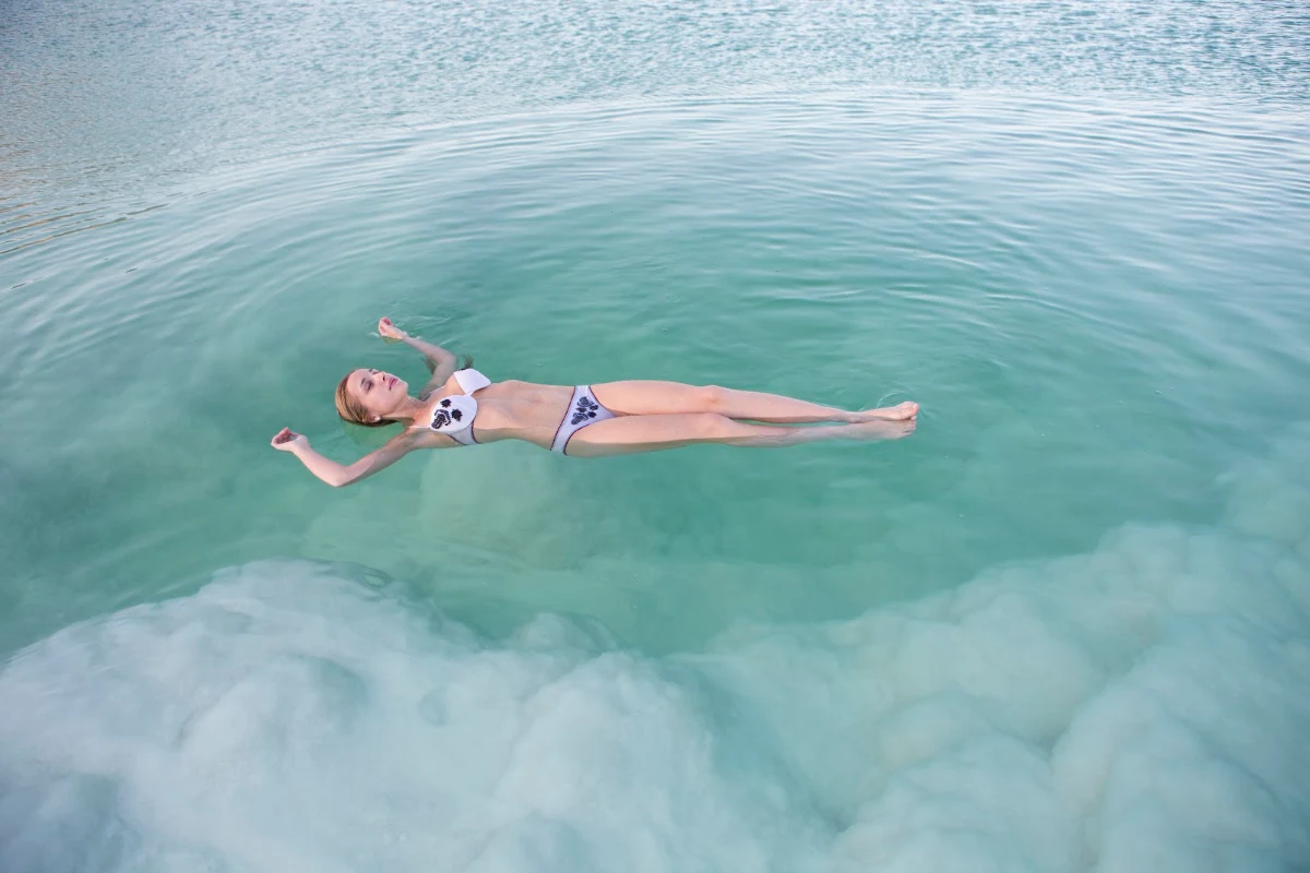 girl-float-dead-sea-Israel - A young woman floats in the Dead Sea, estimated to be the second saltiest major body of water in the world.
