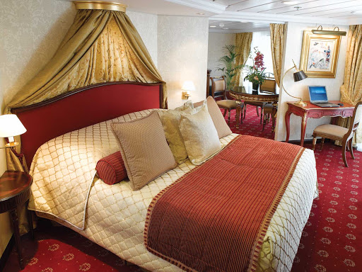 Oceania-Owners-Suite-R-1 - Spanning nearly 1,000 square feet, the Owner's Suite aboard Oceania Regatta includes a queen bed with 1,000-thread-count linens, private teak veranda for watching the passing landscapes, a second bathroom, two flat-screen TVs, laptop, iPad, 24-hour butler service, complimetary in-suite bar setup, priority embarkation and more. 