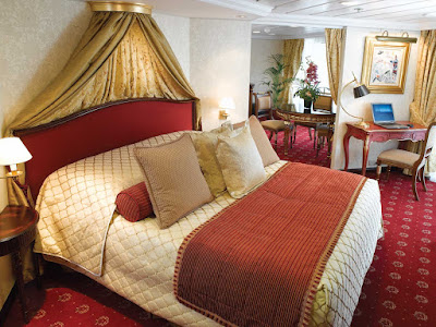 Spanning nearly 1,000 square feet, the Owner's Suite aboard Oceania Regatta includes a queen bed with 1,000-thread-count linens, private teak veranda for watching the passing landscapes, a second bathroom, two flat-screen TVs, laptop, iPad, 24-hour butler service, complimetary in-suite bar setup, priority embarkation and more. 