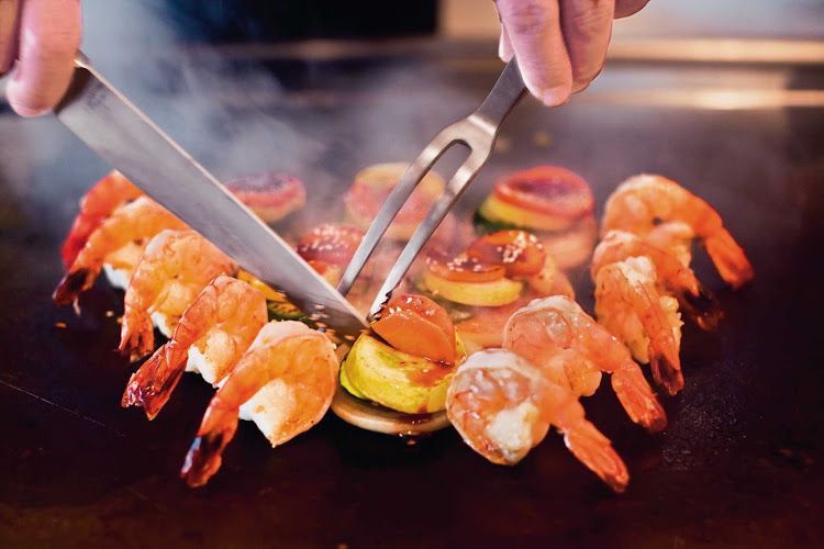 Twirling knives and juicy shrimp straight from the grill add up to a Hibachi style treat at Teppanyaki, an authentic Japanese experience on your Norwegian Cruise Line sailing.