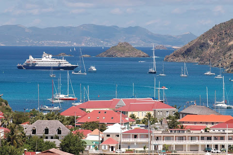 SeaDream II moored off Gustavia, the capital of scenic St. Barts. Take in sweeping vistas during a stay at Le Toiny.