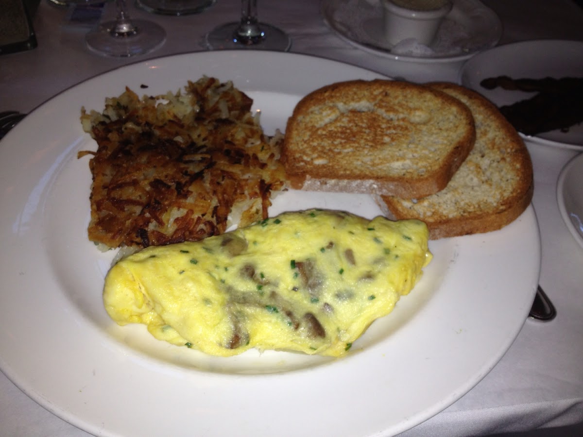 Mushroom & chive omelette with potatoes & gf toast. Can't begin to describe how amazing this was...