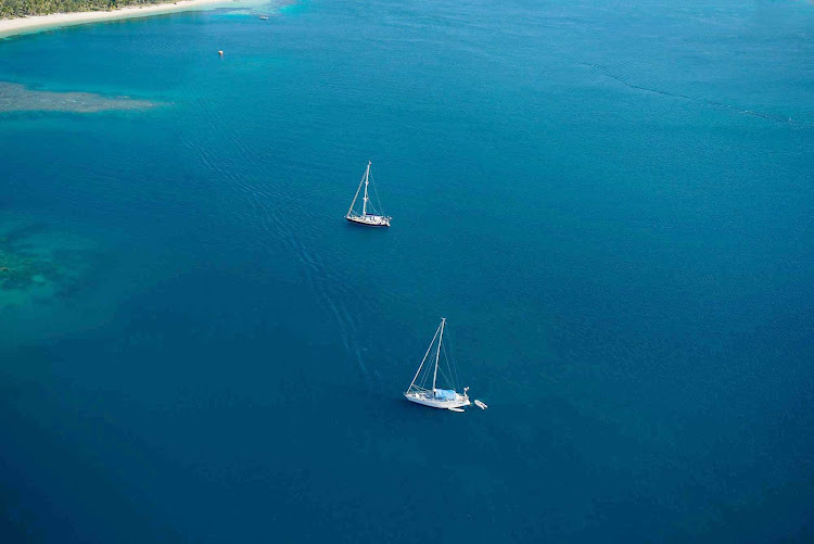 Boating in an azure lagoon in Fiji. 