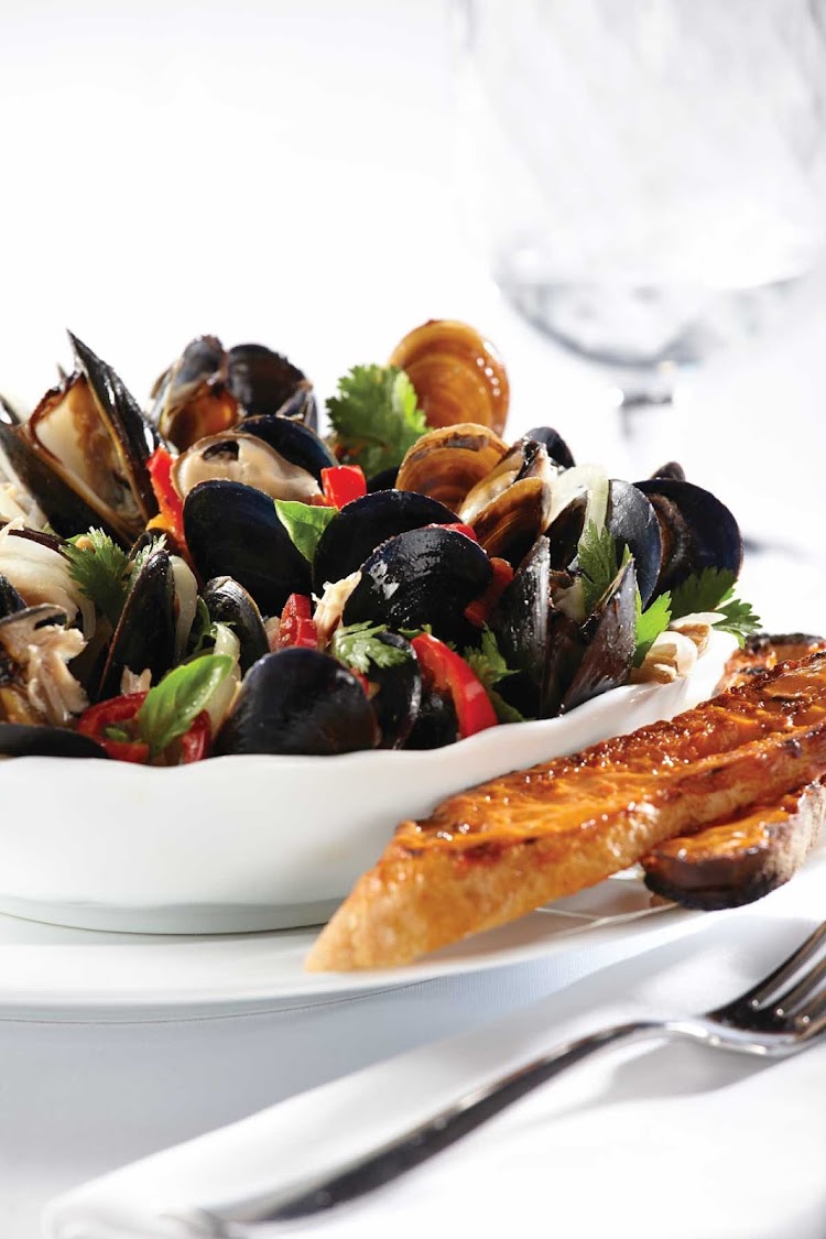 Fresh mussels served at Ocean Blue, the specialty seafood restaurant that focuses on premium ingredients and expert culinary techniques. You'll find it on Norwegian Breakaway and Norwegian Getaway. 