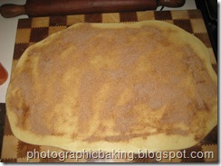 Cinnamon spread on the rolled out dough