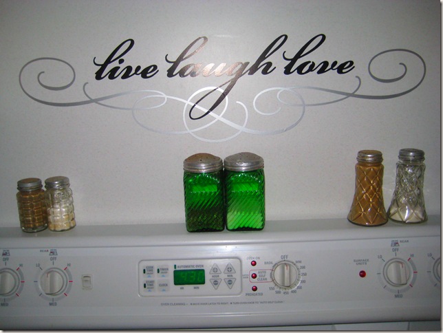 wall behind stove with live laugh love applique