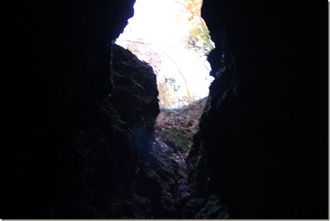 looking up to the opening to outside from inside cave