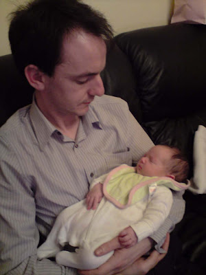 Picture of me with a tiny baby sleeping in my arms