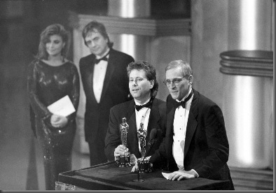 Alan Menken (music) and Howard Ashman (lyrics) accept their Oscars for Best Original Song for "Under the Sea," from the film THE LITTLE MERMAID (1989). Behind them are presenters Paula Abdul and Dudley Moore. Credit: Long Photography / ©A.M.P.A.S.