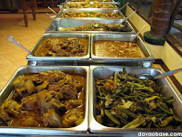 A long table of meat dishes in Nanay Bebeng Restaurant