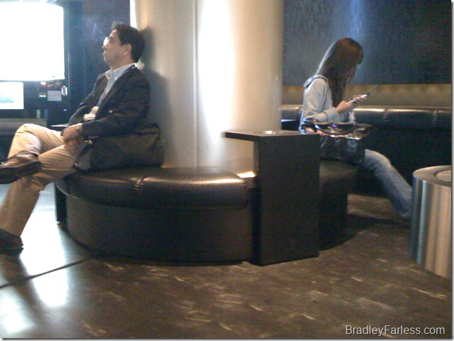 A Japanese man and woman taking a break in a smoking room at Narita Airport in Tokyo, Japan. A Japanese man and woman taking a break in a smoking room at Narita Airport in Tokyo, Japan.