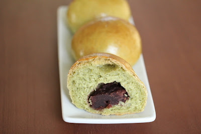 a close-up of a match bread roll sliced in half with the filling showing