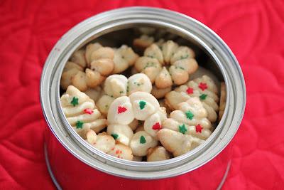 overhead photo of spritz cookies in a container