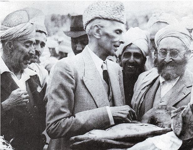 [Quaid-e-Azam accepting a loaf of bread from tribesmen in Khyber Agency[5].png]