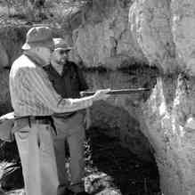 University of Arizona anthropologist C. Vance Haynes and geophysicist Allen West look at the Black Mat Layer during a sampling excursion to the Murray Springs Clovis site in Southern Arizona. Credit: Douglas J. Kennett; Courtesy of the Center for the Study of the First Americans