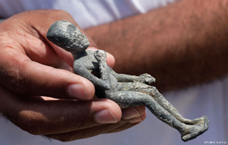 A recently excavated statuette of a boy Pharaoh dating from the 4th or 5th century B.C. is held onboard the Princess Duda research boat, anchored in the harbor of Alexandria