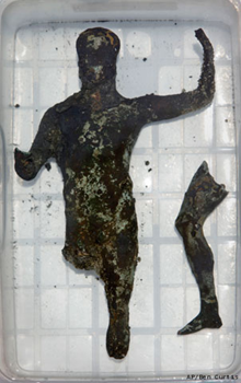 A recently excavated bronze cult statue found in the Temple of Isis sits in a bath of fresh water to desalinate it, onboard the Princess Duda research boat