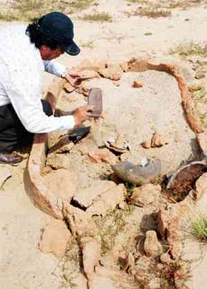 Archaeologist examines one of the jar tombs belonging to Sa Huynh Culture
