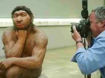 A photographer taking pictures of the Neanderthal man ancestor's reconstruction, displayed in a show of the Prehistoric Museum in Halle, eastern Germany. 