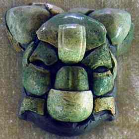 Offering of jadeite mosaics assemble a miniature ceremonial head with a unique bat headdress