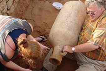 Archeologist Roger Wilson pulls out the clay amphora from its 1,500 year hiding place