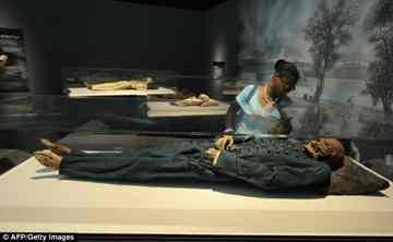 A visitor looks at the 18th century Hungarian mummy of Michael Orlovits