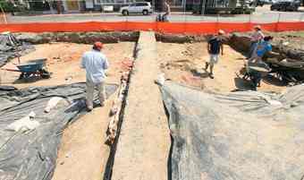 Volunteers work the site of an archaeological dig at the corner of Wine and Queen Streets in downtown Hampton Thursday.