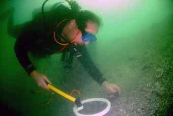 Chas Francoviglia, a member of the “Gold Hound” crew, uses a magnetometer to find iron from a ship’s hardware, which would indicate treasure is nearby.