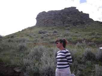 Maria Nieves Zedeno stands at the bottom of the bison jump near the Two Medicine River in the southeast corner of the Blackfeet Indian Reservation. From where Zedeno is standing, the cliff is about 30-feet up.