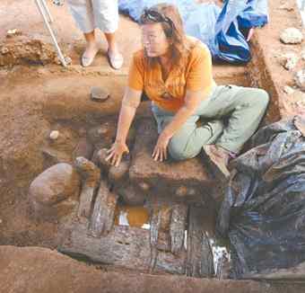 Archaeologist Janet Six explains the process of excavating at Moku‘ula on Wednesday while seated near a section of exposed pier.