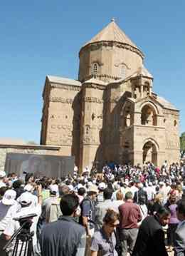 Armenians gather outside the Akdamar Church, inaugurated in AD 921 on Lake Van's Akdamar Island, for the first mass held there since it was abandoned 95 years ago. AP photo